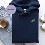 Frog Embroidered Hoodie, Organic Cotton Hoodie, Sustainable Hoodie, Frog Lover Gift, Unisex Frog Hoodie, Eco-Friendly Clothing, Warm Winter Hoodie, Frog Embroidery Design, Cozy Frog Hoodie, Woodland Adventure Hoodie, Recycled Polyester Hoodie, Frog-Themed Apparel, Comfortable Hoodie, Frog Gift Idea, Stylish Embroidered Hoodie, Brushed Fleece Hoodie, Animal Embroidery Hoodie, Frog Enthusiast Gift, Relaxation Hoodie, Unique Frog Clothing.